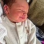 Ruairi is registered to the contest to win money with this photo: baby, newborn, sleeping, smile, onesie, white_clothing, teddy_bear, infant, face, head, cushion, blanket, soft_texture, peaceful, closeup, portrait, child, cozy, indoors, resting