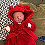 Ruairi joined the competition — help win amazing prizes! baby, newborn, sleeping, red_robe, hood, couch, cushions, soft_fabric, infant, cute, cozy, indoors, resting, child, small_hands, patterned_pillow, white_clothing, relaxation, warm, portrait