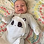 baby, babylaughing, bed, bedroom, blanket, clothing, cushion, face, furniture, glove, happy, head, homedecor, newborn, person, photography, portrait, quilt, sleeping, smile