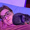 Annabelle joined the competition — help win amazing prizes! cat, tabby_cat, kitten, person, woman, face, glasses, sleeping, cuddling, pet, feline, fur, gray_fur, bed, pillow, bedroom, selfie, indoor, purple_lighting, portrait