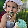 child, cone, cute, face, food, fun, green_ice_cream, happy, hat, ice_cream, messy, mint_chocolate_chip, outdoor, pink_hat, playful, portrait, smile, summer, tank_top, toddler