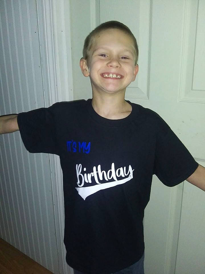 Tyler is registered to the contest to win money with this photo: arm, child, clothing, joint, joy, neck, person, shirt, shoulder, sleeve, smile, sportswear, t_shirt, top