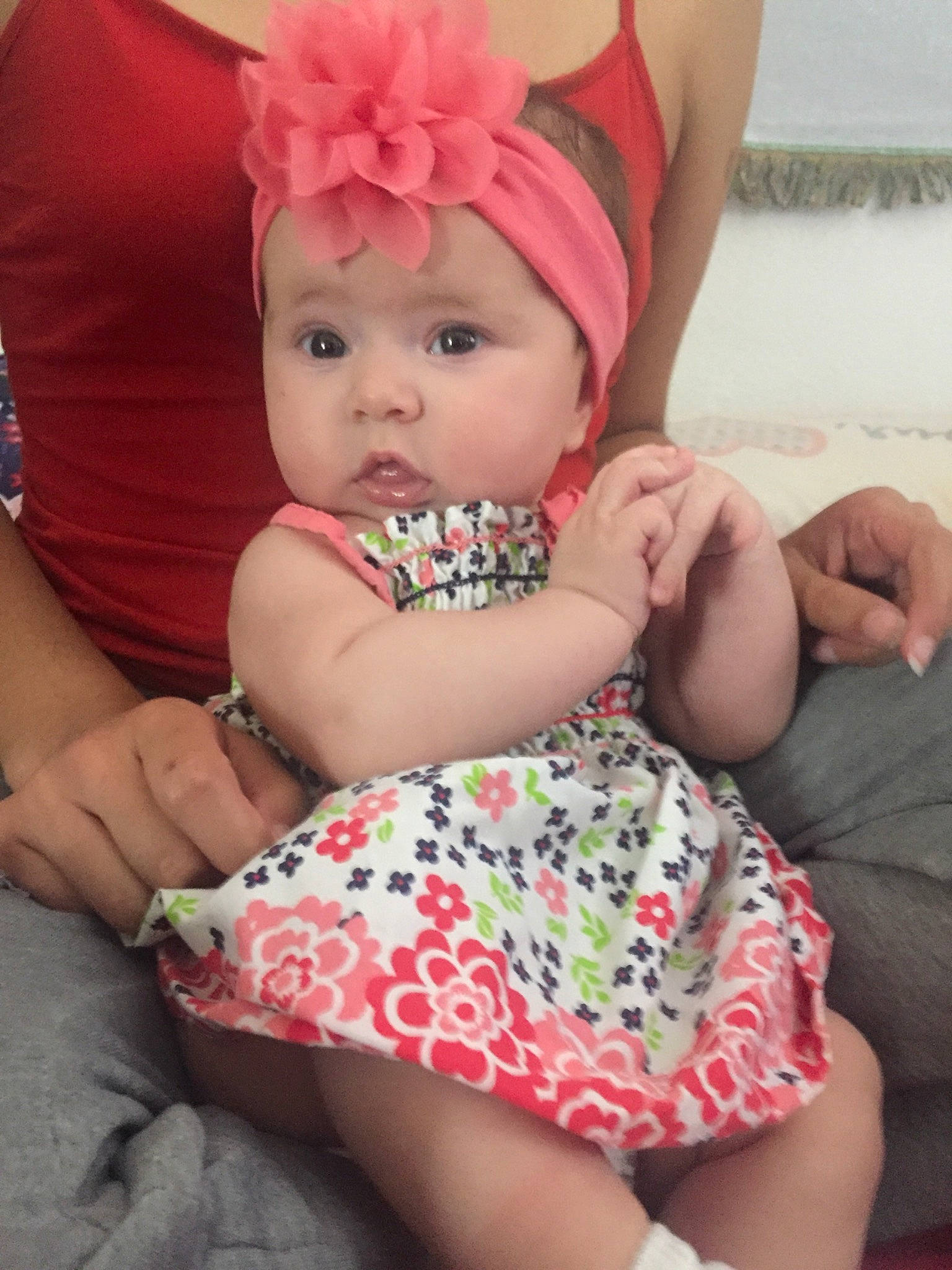 Malayah is registered to the contest to win money with this photo: baby, baby_products, baby_toddler_clothing, cheek, child, hair_accessory, headgear, headwear, person, pink, sitting, skin, toddler