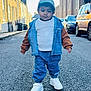asphalt, buildings, cap, casual_clothing, child, confidence, cool, daytime, denim_jacket, fashion, outdoor, person, sidewalk, small_person, street, toddler, urban, walking, white_shoes, young_child