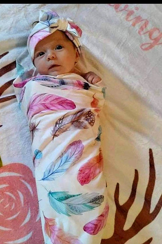 Lydia joined the competition — help win amazing prizes! baby, baby_products, baby_toddler_clothing, dress, eye, eyelash, face, fashion_accessory, head, headgear, headwear, linens, magenta, pattern, peach, person, pink, skin, sleeve, t_shirt