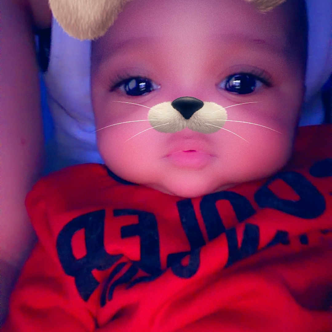 Khaisen is registered to the contest to win money with this photo: baby, casual_clothing, child, closeup, cute, digital_filter, dog_ears, dog_nose, expressionless, face_filter, head_and_shoulders, human_face, indoors, infant, person, portrait, red_clothing, soft_lighting, whiskers, young_child