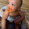 Khaisen joined the competition — help win amazing prizes! arms, baby, baby_seat, carpet, cheeks, child, cute, floor, food, home, indoor, infant, legs, messy_face, orange_sauce, playful, sitting, smiling, toes, wood_floor