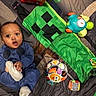baby, bright, child, clothing, colorful, cute, expression, face, floor, fun, indoor, infant, lying, person, play, playmat, socks, soft, toy, young