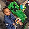 Khaisen joined the competition — help win amazing prizes! baby, ball, blanket, blue_clothing, child, comfortable, curious, cute, expression, face, floor, indoor, infant, mickey_mouse, play_mat, sitting, smiling, soft_toy, toys, young_child