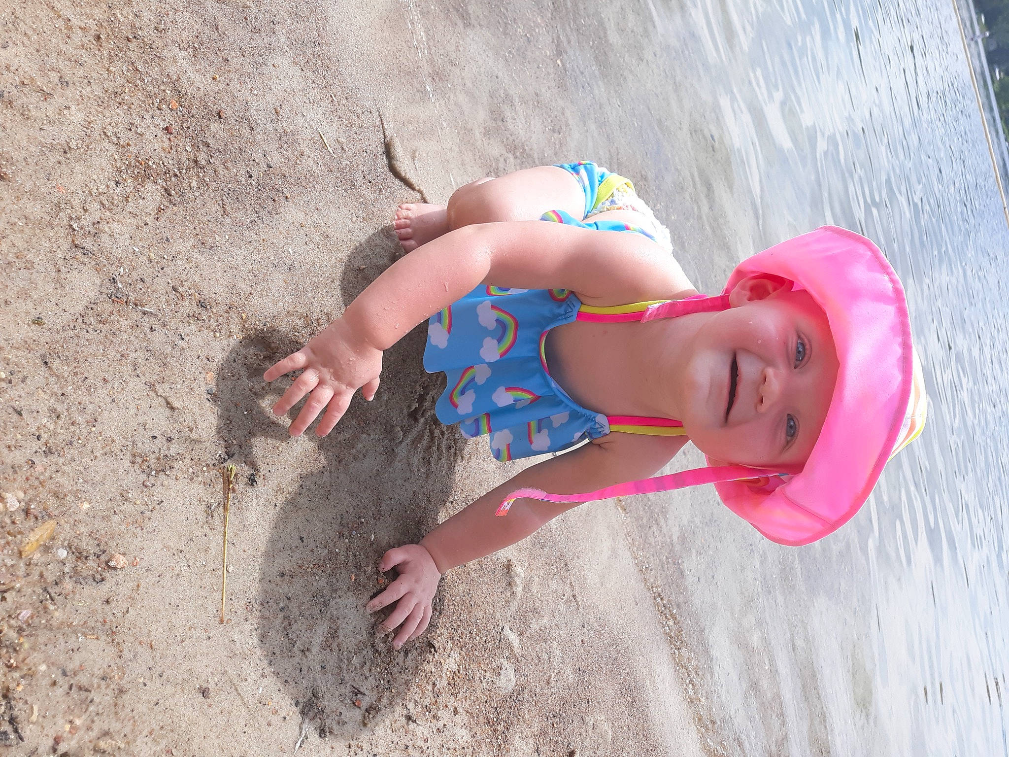 Ellieanna joined the competition — help win amazing prizes! azure, beach, body_of_water, finger, fun, happy, hat, headgear, headwear, human_body, joy, leg, leisure, people_in_nature, people_on_beach, person, recreation, sand, smile, sun_hat