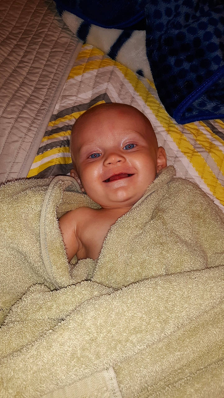 Ellieanna joined the competition — help win amazing prizes! baby, bedding, bedtime, blanket, cheek, child, chin, comfort, flooring, laugh, linens, nose, pattern, person, room, skin, sleep, smile, textile, toddler
