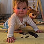 baby, infant, crawling, play_mat, plush_bear, teddy_bear, toy, big_eyes, face, hands, onesie, indoor, nursery, play_gym, floor_mat, close_up, portrait, chubby_cheeks, carpet, cozy