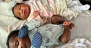 Gavianna'S is registered to the contest to win money with this photo: babies, baby_clothing, blanket, cartoon_pattern, child, closeup, couch, cozy, family, indoors, infant, lying_down, matching_outfits, newborn, onesie, peaceful, portrait, sleeping, socks, twins