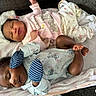 babies, baby_clothing, blanket, cartoon_pattern, child, closeup, couch, cozy, family, indoors, infant, lying_down, matching_outfits, newborn, onesie, peaceful, portrait, sleeping, socks, twins