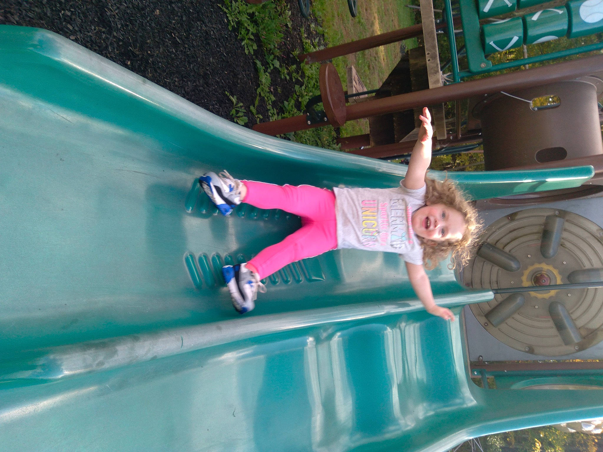 Skyla joined the competition — help win amazing prizes! automotive_exterior, chute, city, clothing, electric_blue, fun, green, leisure, magenta, motor_vehicle, outdoor_play_equipment, person, plant, playground, playground_slide, recreation, shorts, smile, t_shirt, toddler