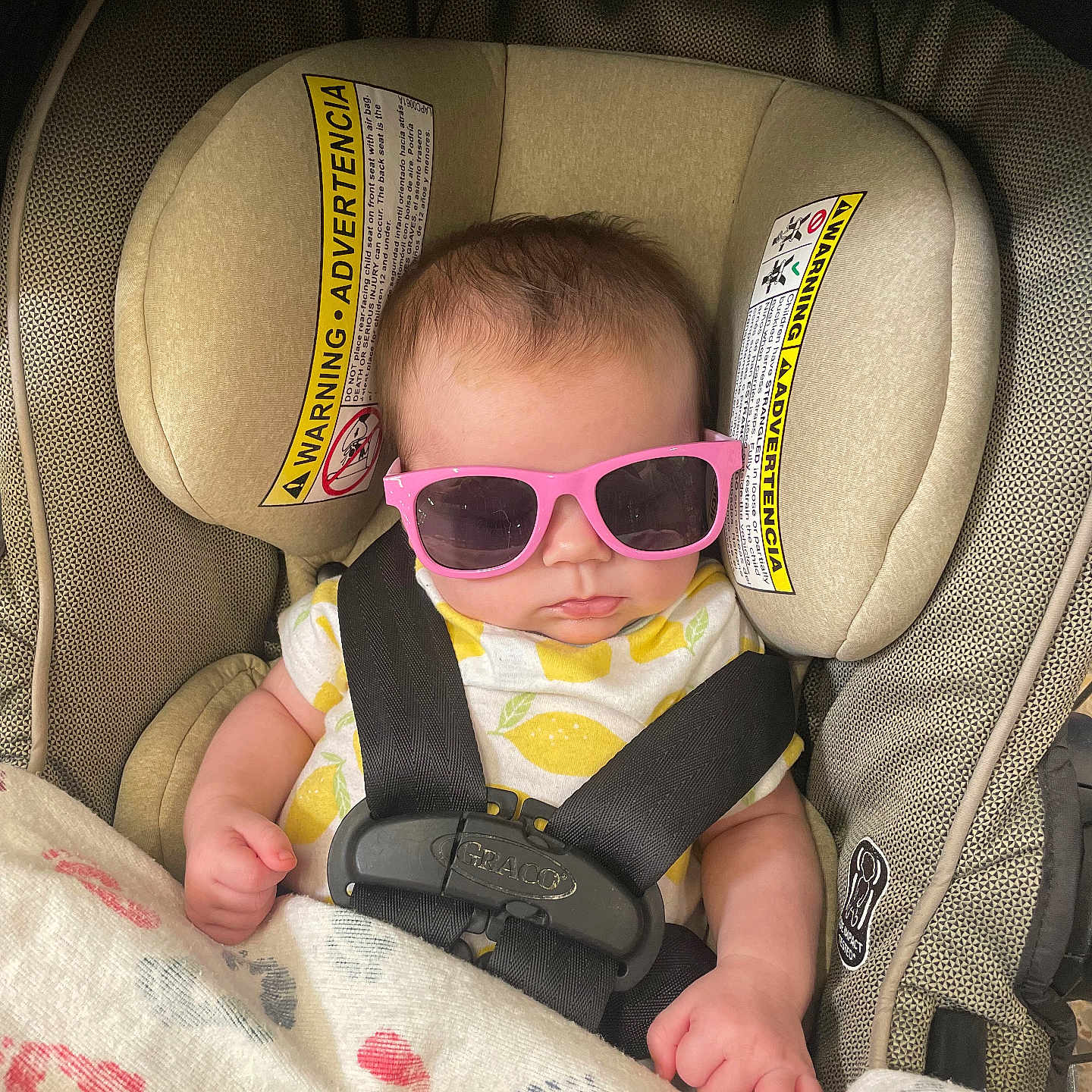 Oakley Marie joined the competition — help win amazing prizes! adorable, baby, blanket, car_seat, child, clothing, cute, face, hands, head, indoor, infant, lemon_pattern, pink, portrait, relaxed, safety, seatbelt, sunglasses, yellow