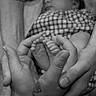 Braylee is registered to the contest to win money with this photo: newborn, baby, sleeping, infant, feet, toes, hands, adult, parent, cradling, checkered_clothing, portrait, black_and_white, close_up, tender, family, indoors, blanket, tattoo, peaceful