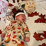 baby, newborn, sleeping, smiling, portrait, autumn, leaves, onesie, headband, bow, milestone, one_month, nursery, plush_toy, deer, blanket, bed, flowers, fall_decorations, infant