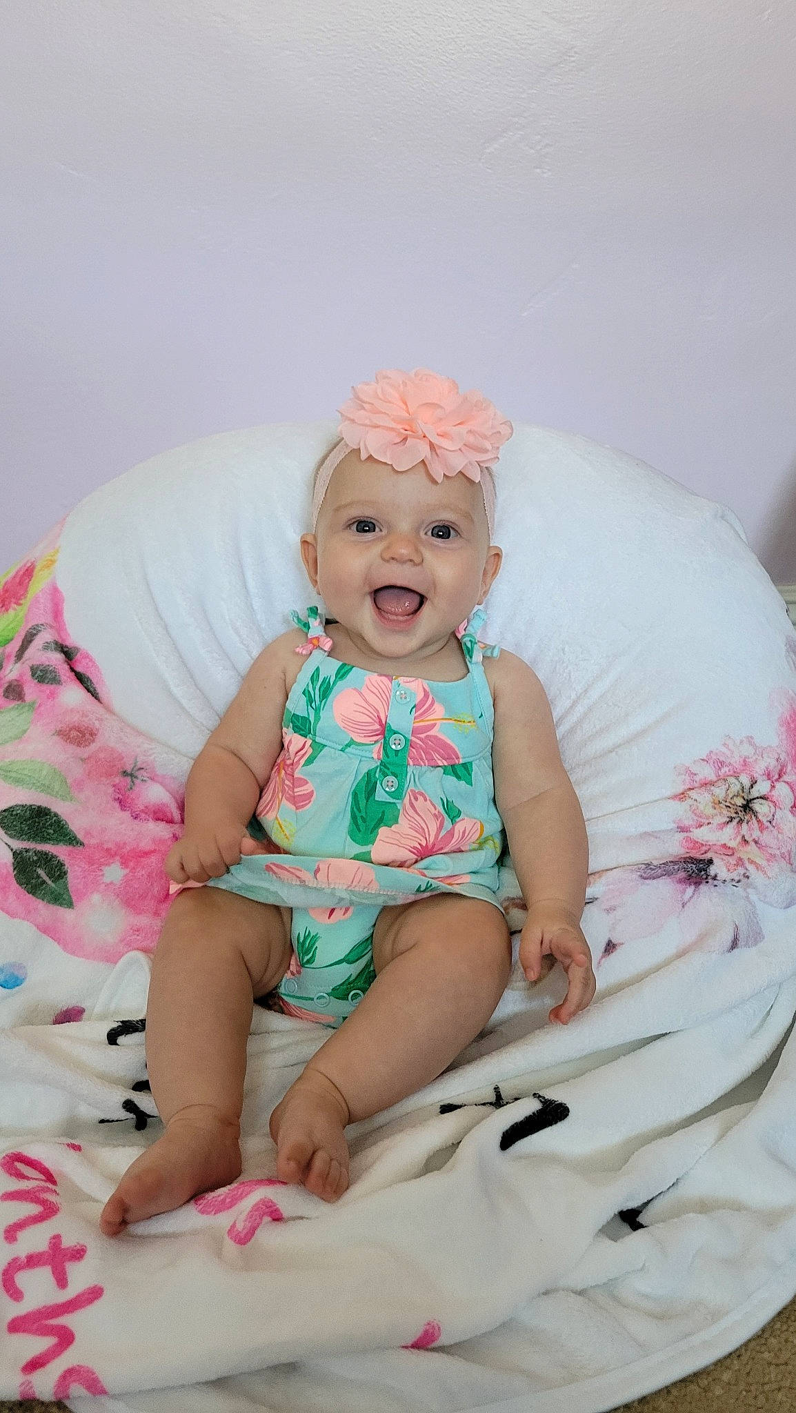 Evelyn joined the competition — help win amazing prizes! baby, baby_toddler_clothing, child, comfort, couch, fun, hand, happy, headgear, headwear, linens, magenta, pattern, person, pink, skin, sleeve, smile, t_shirt, textile