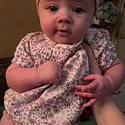 Amelia Rose is registered to the contest to win money with this photo: baby, child, clothing, cute, expression, face, floral_top, hand, headband, holding, indoor, infant, person, pink_bow, pink_pants, portrait, sitting, skin, soft_lighting, young_child