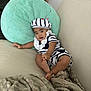 baby, blanket, child, comfortable, couch, cozy, curious, cute, furniture, hat, home, indoor, infant, person, pillow, portrait, relaxed, smiling, soft_texture, striped_clothing