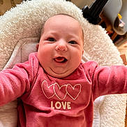 Charlie a rejoint le concours — aidez-le/la à gagner de superbes lots ! baby, infant, smiling, pink_clothing, love_text, hearts, blanket, cozy, happy, cute, portrait, indoor, child, face, head, young, sitting, warm, soft, cuddly