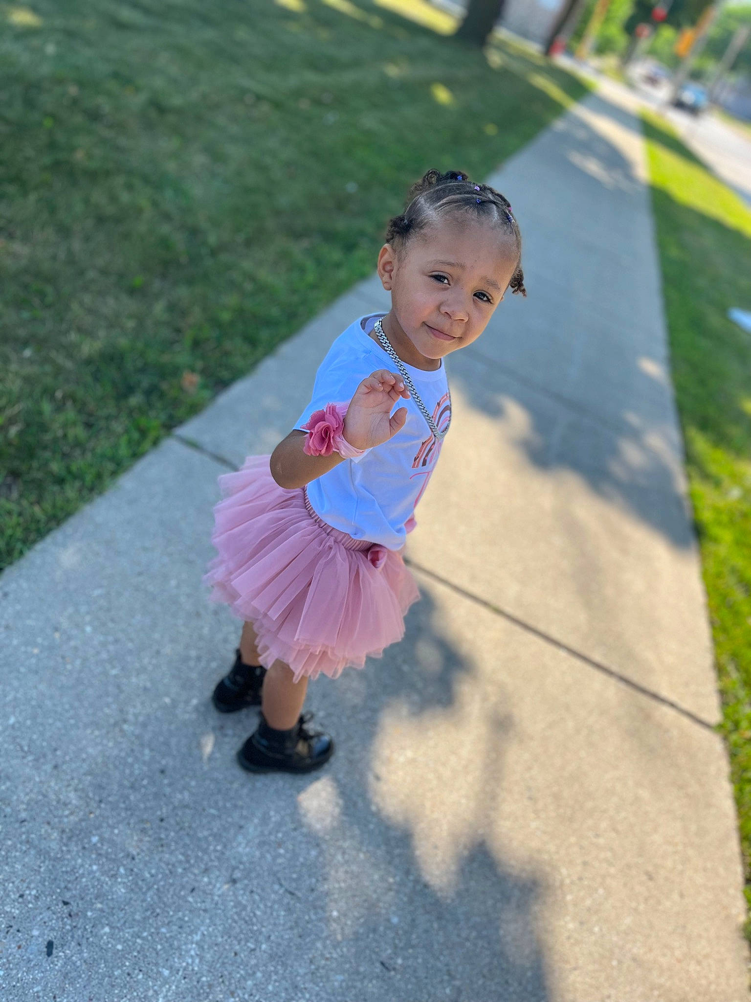 Lilionnie is registered to the contest to win money with this photo: asphalt, baby, event, eye, footwear, grass, happy, leisure, magenta, pedestrian, person, pink, plant, recreation, road, road_surface, sandal, sidewalk, toddler, tree