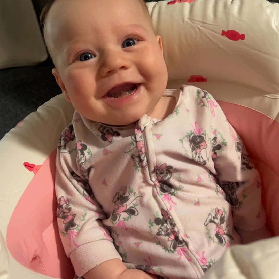 Mavery joined the competition — help win amazing prizes! baby, smiling, infant, onesie, pink, minnie_mouse, baby_seat, cushion, happy, child, indoor, cute, face, portrait, sitting, young_child, clothing, comfort, expression, person