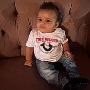 Zamarii is registered to the contest to win money with this photo: brown, casual, child, clothing, couch, cute, expression, face, furniture, home, indoor, jeans, person, portrait, real_photo, seated, shirt, sitting, toddler, young_child