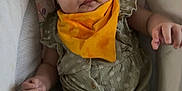 Lové is registered to the contest to win money with this photo: adorable, baby, child, closeup, comfort, cushion, cute, expression, fabric, floral_pattern, indoor, infant, looking_at_camera, portrait, romper, seated, small_hands, soft_lighting, yellow_bib, young_child