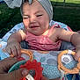 Lové is registered to the contest to win money with this photo: baby, bow, child, childhood, closeup, cute, face, hands, happy, headband, infant, outdoor, pink_dress, plastic_rings, playing, polka_dot, seat, smiling, sunlight, toy