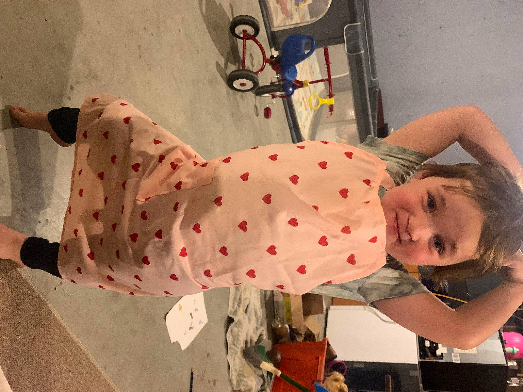 Rosalie is registered to the contest to win money with this photo: baby_products, bicycle_handlebar, bicycle_wheel, carmine, child, costume, entertainment, fun, leisure, pattern, person, polka_dot, recreation, room, smile, tire, toddler, toy, visual_arts