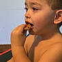 Lukas joined the competition — help win amazing prizes! bare_shoulders, brown_eyes, casual, child, closeup, cookie, eating, face, focus, food, hand, indoor, light_skin, natural_light, portrait, short_hair, side_view, snack, sweet, young