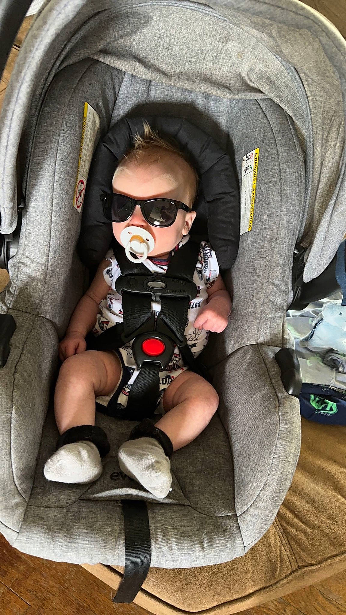 Colton is registered to the contest to win money with this photo: auto_part, baby, baby_carriage, baby_products, baby_safety, baby_toddler_clothing, bag, car_seat, carmine, child, comfort, eyewear, goggles, pattern, person, personal_protective_equipment, sitting, sleeve, sunglasses, toddler