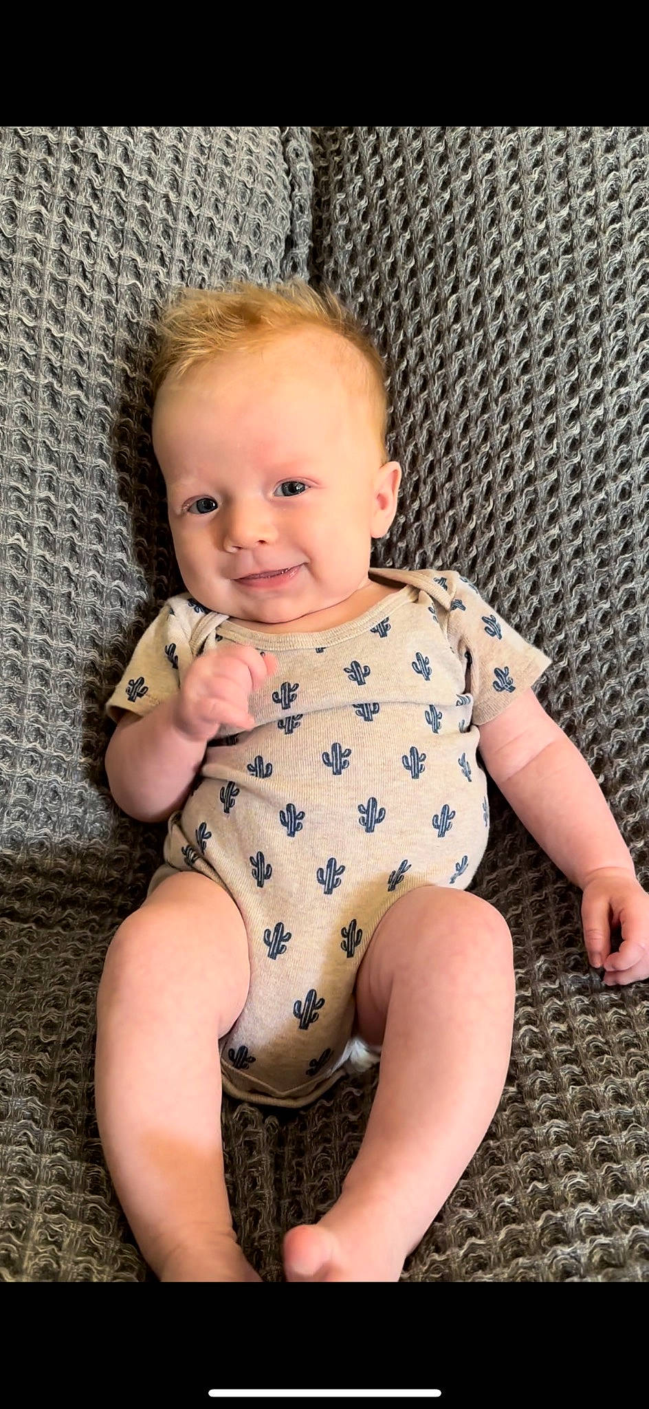 Colton is registered to the contest to win money with this photo: arm, baby_toddler_clothing, cheek, chin, eye, face, facial_expression, finger, head, human_body, iris, joint, joy, leg, lip, person, skin, sleeve, smile, standing