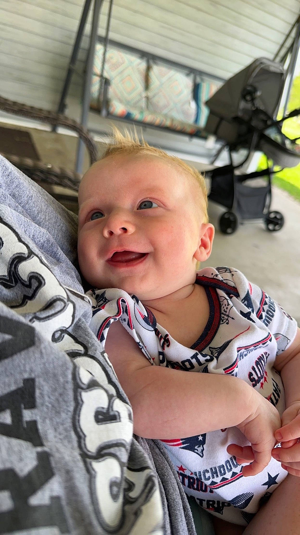 Colton is registered to the contest to win money with this photo: baby, baby_carriage, baby_products, baby_toddler_clothing, camouflage, cheek, child, comfort, eye, fun, hairstyle, happy, head, military_camouflage, person, sitting, skin, sleeve, smile, t_shirt