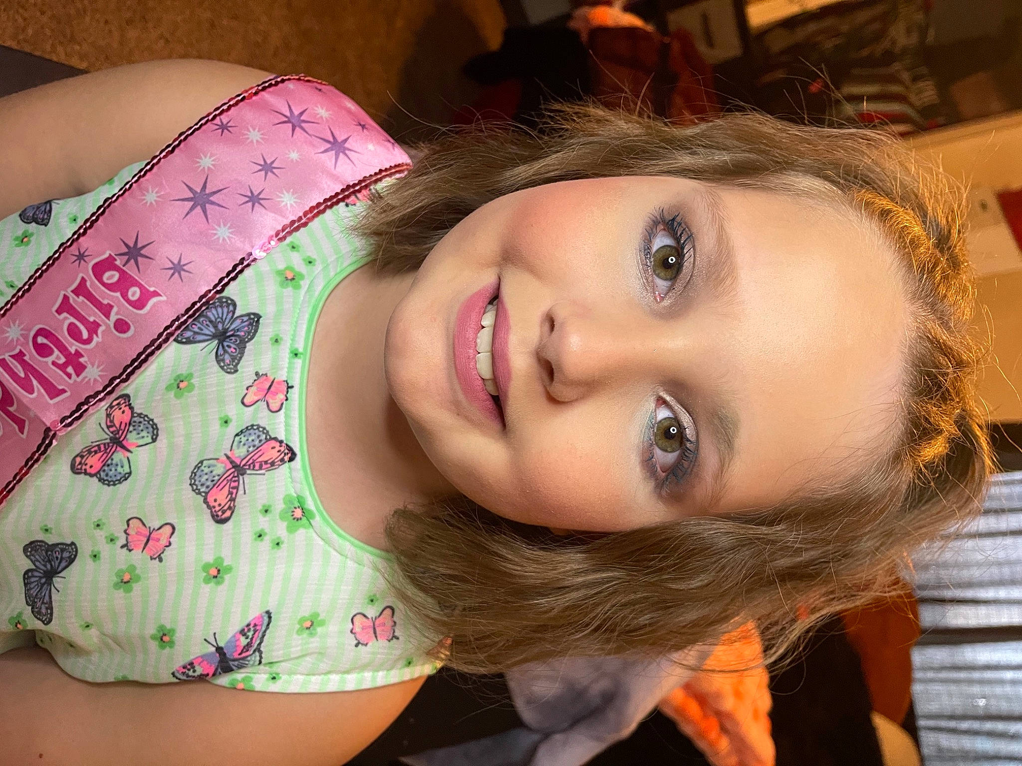 Coco is registered to the contest to win money with this photo: cheek, chin, dress, eyebrow, eyelash, facial_expression, forehead, hairstyle, happy, human, iris, jaw, joy, lip, mouth, neck, nose, person, plant, shoulder