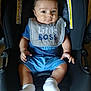 baby, child, car_seat, bib, blue_clothing, white_socks, sitting, indoors, infant, cute, portrait, young_child, seat, hands, legs, footwear, fabric, warning_label, expression, person