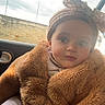 baby, bow, car_interior, child, coat, curious, cute, face, fuzzy, headband, indoor, knitted, person, polka_dot, portrait, seat, soft_light, warm_clothing, window, young_child