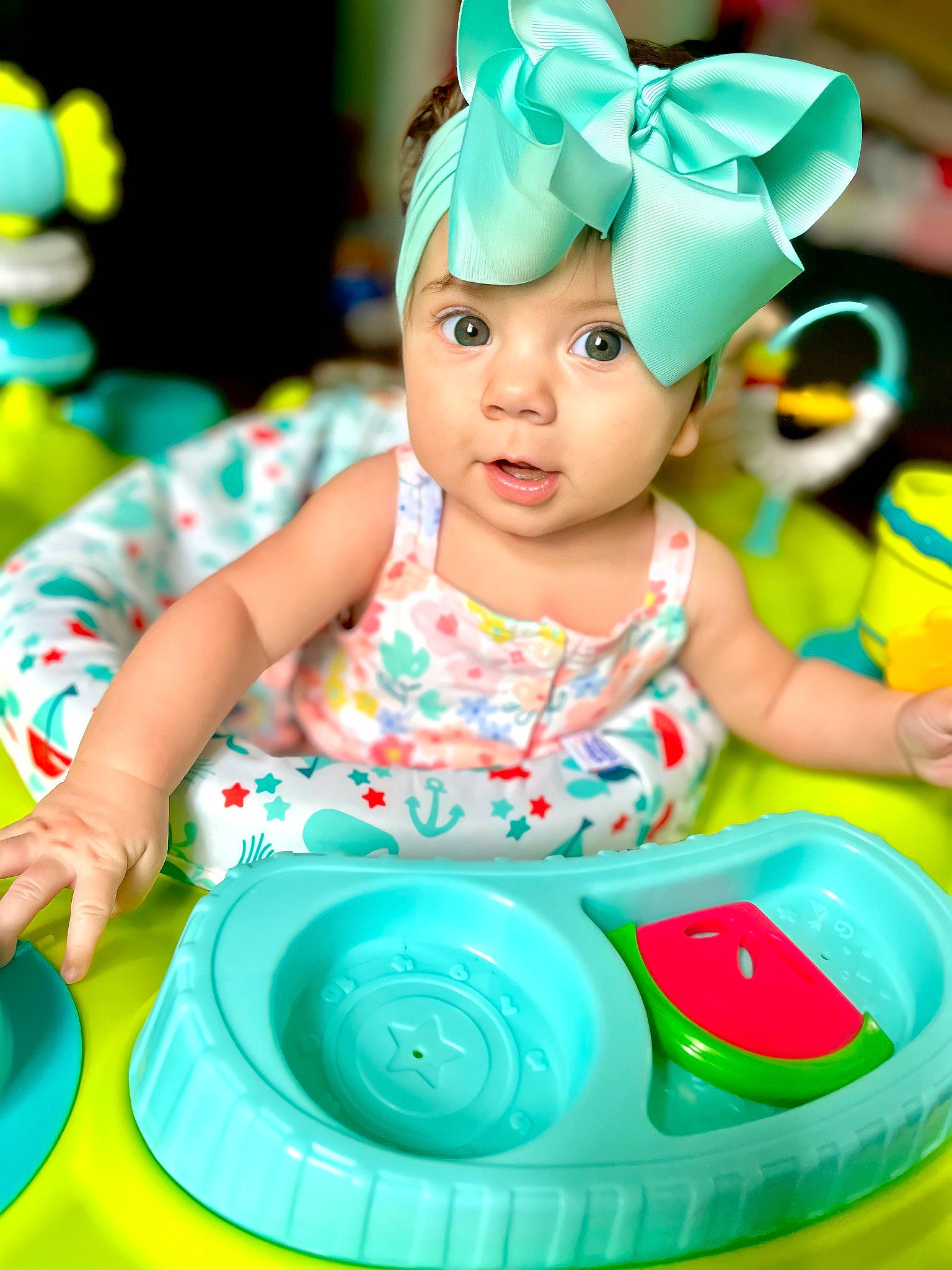 Cora is registered to the contest to win money with this photo: aqua, baby, baby_playing_with_toys, baby_products, child, drinkware, event, fun, green, happy, headpiece, headwear, icing, leisure, party, party_supply, person, pink, plastic, recreation