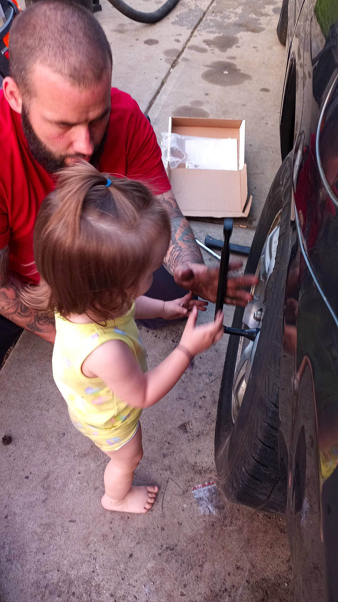 Maxine is registered to the contest to win money with this photo: automotive_design, automotive_exterior, automotive_tire, bumper, car, child, fender, fun, head, leisure, motor_vehicle, person, product, rim, shorts, t_shirt, tire, toddler, tread, vehicle_door