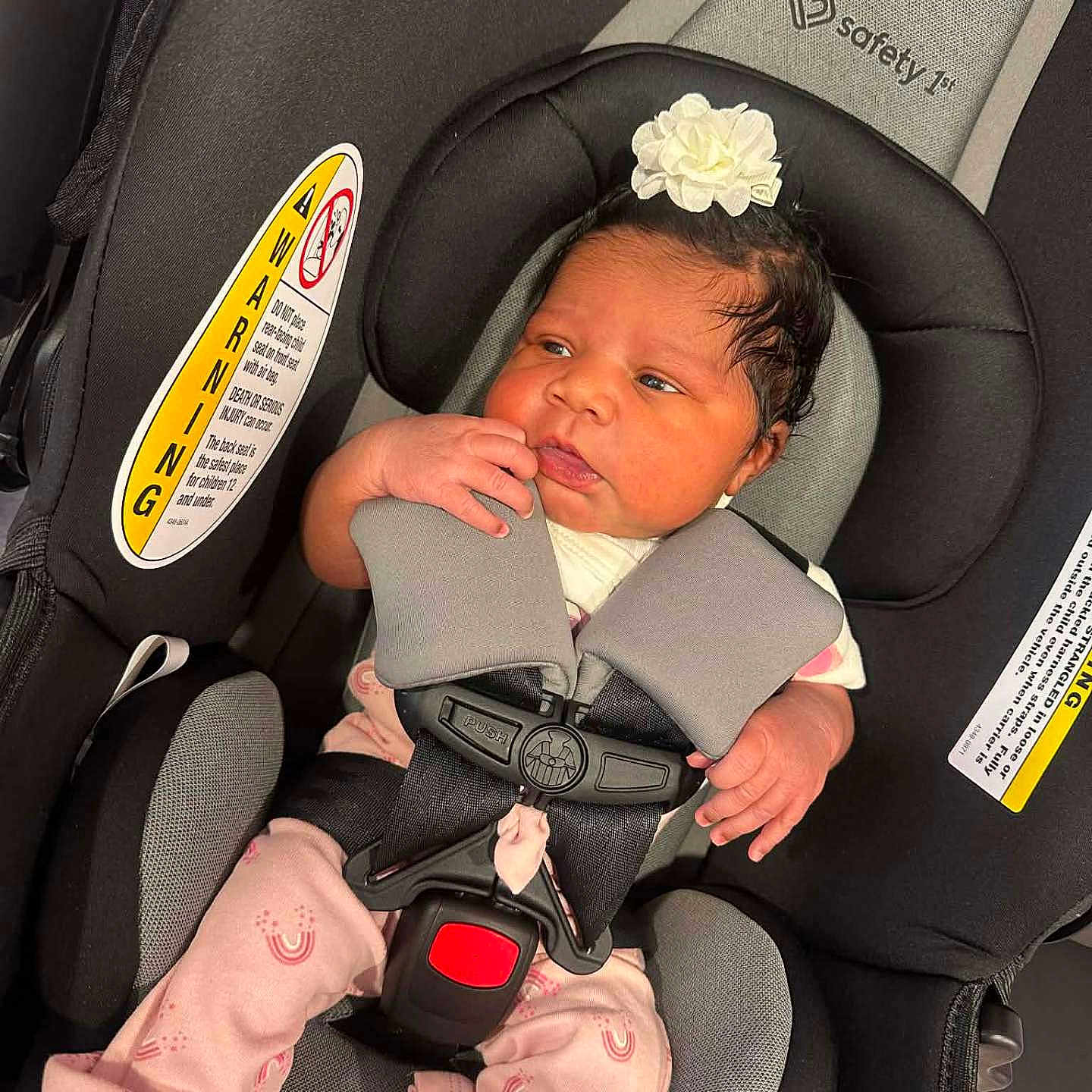 Za'Niyah Washington joined the competition — help win amazing prizes! baby, baby_clothes, baby_girl, car_interior, car_seat, child, clothing, cute, flower_headband, headwear, indoors, infant, newborn, person, pink_pajamas, portrait, resting, safety_harness, seat_belt, young_child