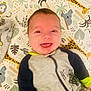 Gus joined the competition — help win amazing prizes! animal_print, baby, blanket, child, colorful, cozy, cute, face, giraffe, happy, indoors, infant, koala, lying_down, onesie, pattern, person, smiling, soft_toys, young_child