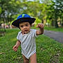 Lucas is registered to the contest to win money with this photo: toddler, child, outdoor, grass, hat, onesie, dinosaur, walking, nature, greenery, park, young_child, curious, summer, footwear, baby, person, cute, sunlight, playful