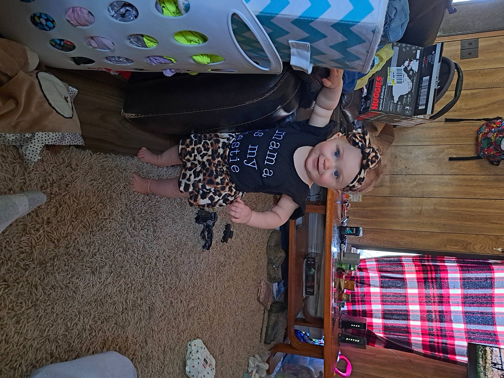 Heather is registered to the contest to win money with this photo: automotive_tire, flooring, fun, hat, headwear, joy, leisure, pattern, person, personal_protective_equipment, plaid, plastic, room, tartan, tire, wheel