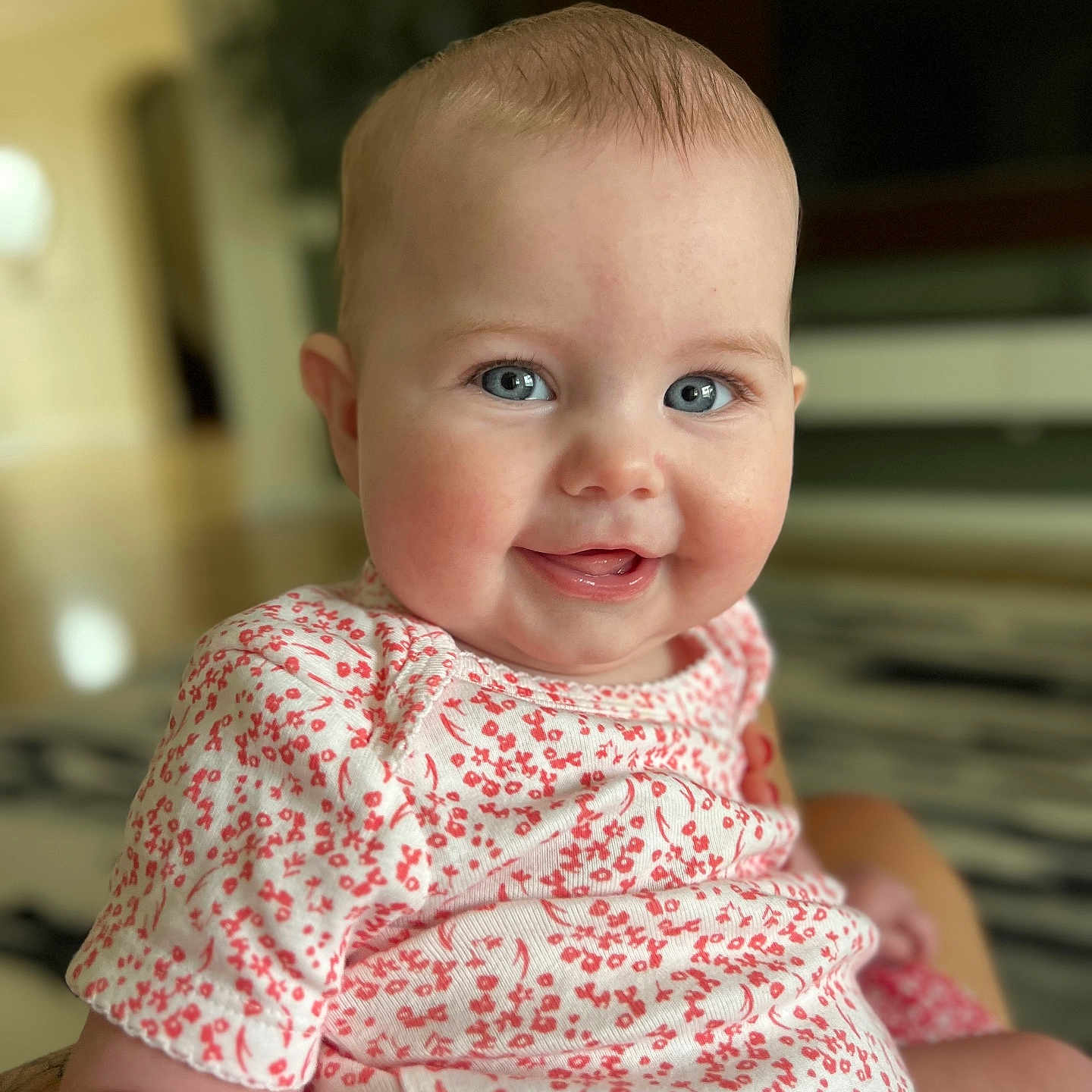 Emily joined the competition — help win amazing prizes! baby, babylaughing, blouse, bodypart, clothing, dress, face, happy, head, laughing, mouth, newborn, pattern, person, photography, portrait, shirt, sitting, smile, teeth