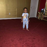 Javis C. Tie joined the competition — help win amazing prizes! toddler, child, pajamas, barefoot, red_carpet, indoor, door, wall, yellow_wall, red_wall, small_table, electronic_device, carpet, person, foot, standing, room, furniture, clothing, home