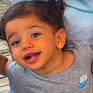 Inaya participe au concours pour gagner de l'argent avec cette photo : toddler, child, smiling, curly_hair, face, grey_shirt, nike_logo, happy, outdoor, person, portrait, cute, young_child, skin, head, eyes, mouth, casual_clothing, expression, joyful