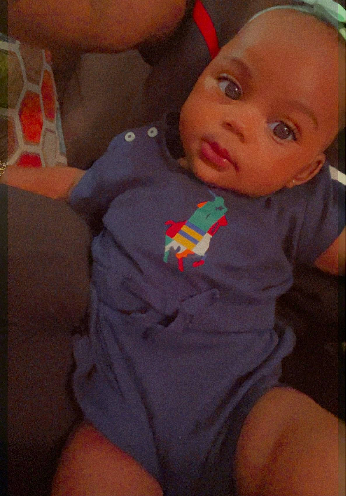 Angel is registered to the contest to win money with this photo: baby, baby_toddler_clothing, cheek, eye, finger, hair, happy, iris, leg, lip, mouth, neck, nose, orange, person, skin, sleeve, sportswear, thigh, toddler