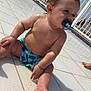 baby, child, pacifier, water, wet_skin, poolside, tiled_floor, sunlight, shadow, bracelet, blue_swim_diaper, outdoor, summer, sitting, cute, infant, skin, foot, hand, face
